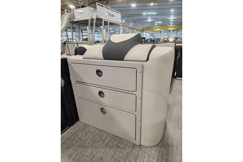 Slide: The Image of 2026 Tahoe Pontoon 25E85 LTZ Rear Bench with plastic-covered seating, outdoor setting. - 16