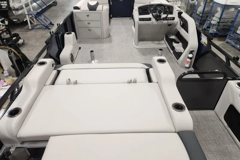 Slide: The Image of 2026 Tahoe Pontoon 25E85 LTZ Rear Bench boat cockpit with steering wheel and controls. - 25