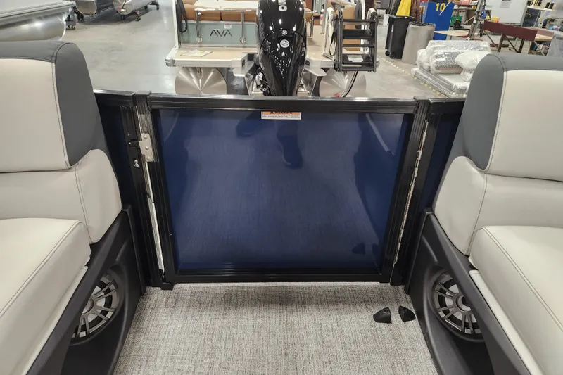Slide: The Image of 2026 Tahoe Pontoon 25E85 LTZ Rear Bench storage compartment with bubble wrap and wiring. - 34
