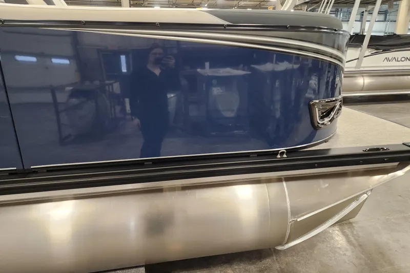 Slide: The Image of 2026 Tahoe Pontoon 25E85 LTZ Rear Bench, sleek design, parked outdoors. - 4