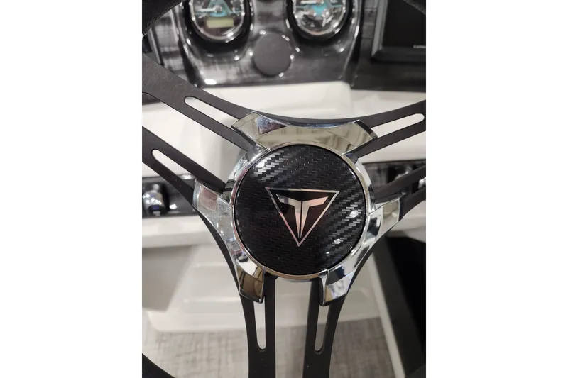 Slide: The Image of 2026 Tahoe Pontoon 23 LTZ Rear Bench with sleek blue exterior in a showroom. - 44