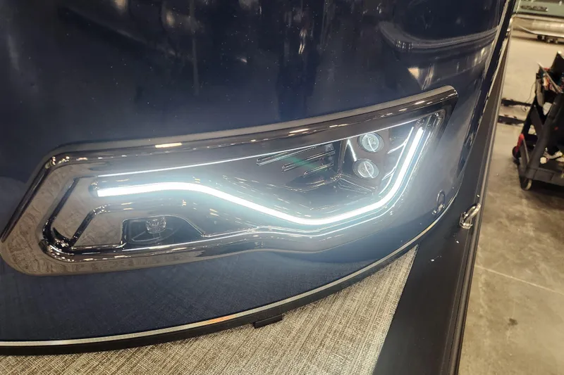 Slide: The Image of 2026 Tahoe Pontoon 23 LTZ Rear Bench with blue LED lighting and modern design. - 53