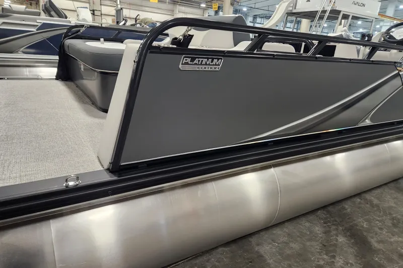 Slide: The Image of 2026 Tahoe Pontoon 25E85 LTZ Rear Bench with Mercury engine, docked outdoors. - 6
