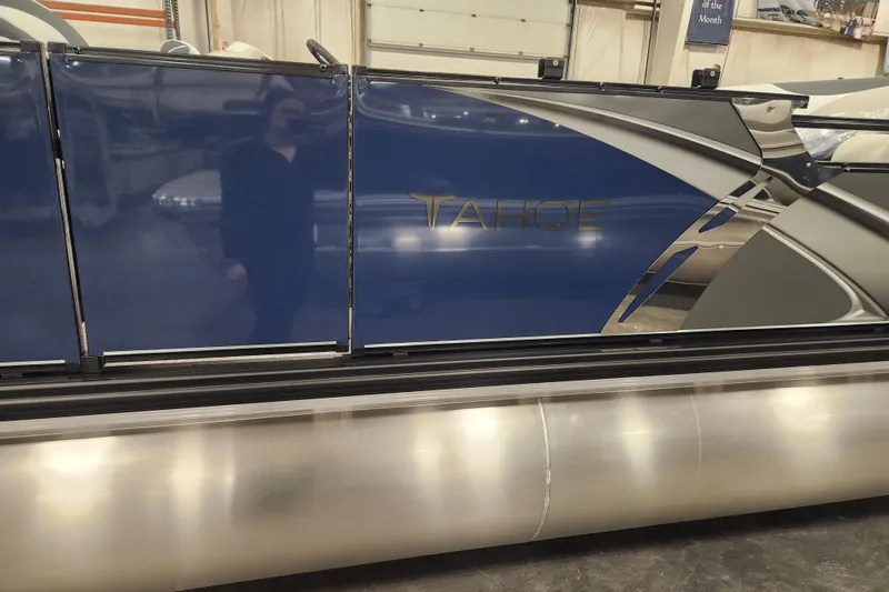 Slide: The Image of 2026 Tahoe Pontoon 23 LTZ Rear Bench with elegant gray and white seating in a warehouse setting. - 75