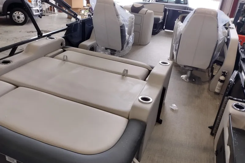 Slide: The Image of 2026 Tahoe Pontoon 23 LTZ Rear Bench interior with safety gate in a manufacturing setting. - 90