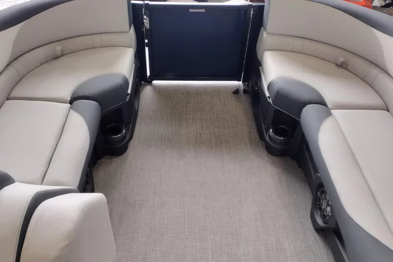 Slide: The Image of 2026 Tahoe Pontoon 23 LTZ Rear Bench dashboard with controls and cup holder. - 92