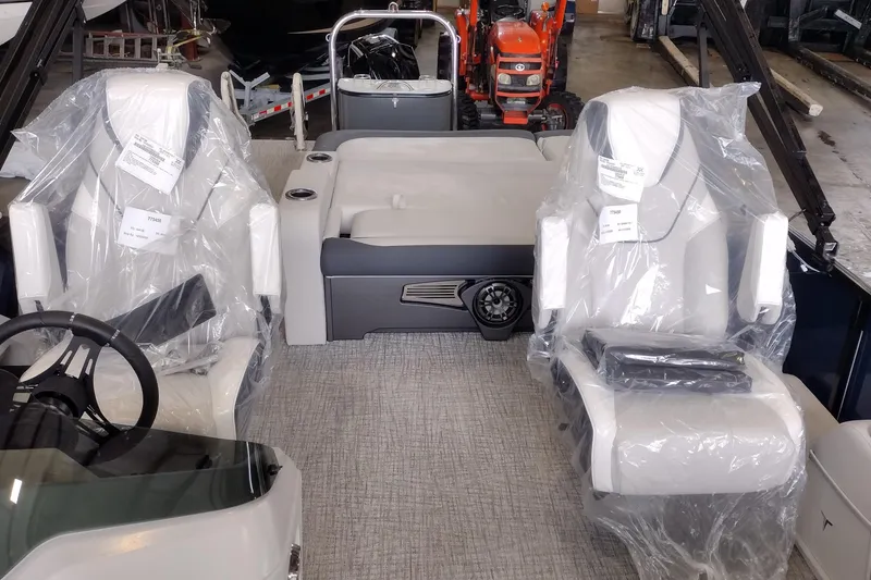 Slide: The Image of 2026 Tahoe Pontoon 23 LTZ Rear Bench dashboard with control panel and cup holder. - 95