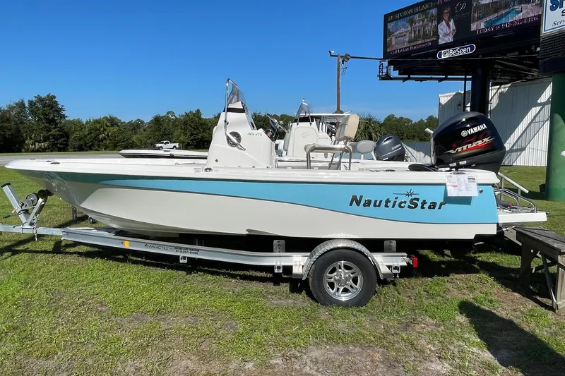 The Image of 2022 NauticStar 195 XTS boat on trailer under blue sky. - 0