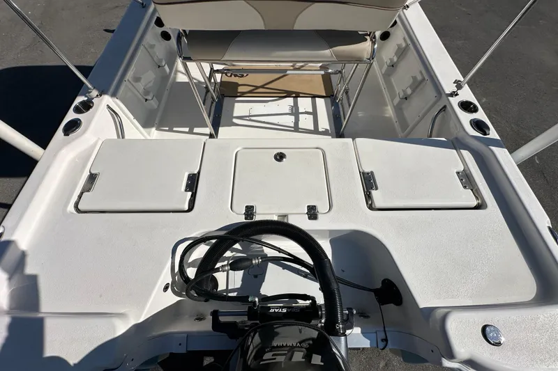 Slide: The Image of 2022 NauticStar 195 XTS boat interior with Yamaha 115 engine, storage compartments, and seating. - 18
