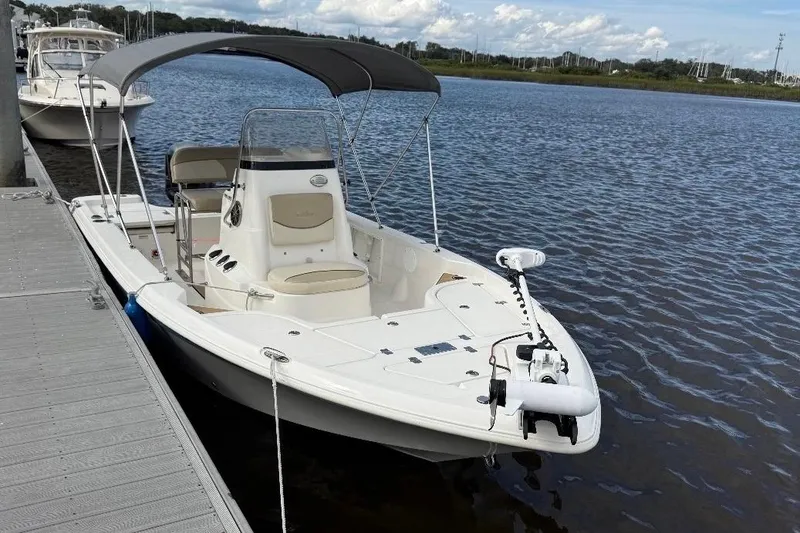 Slide: The Image of 2022 NauticStar 195 XTS boat with Yamaha VMAX engine, parked outdoors. - 2