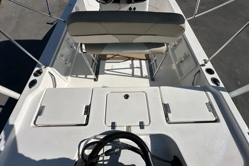 Slide: The Image of 2022 NauticStar 195 XTS boat interior with seating and storage compartments. - 20