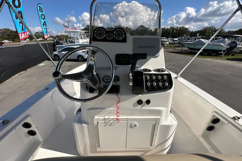 Slide: The Image of 2022 NauticStar 195 XTS boat console with Garmin system, steering wheel, and control panel. - 24