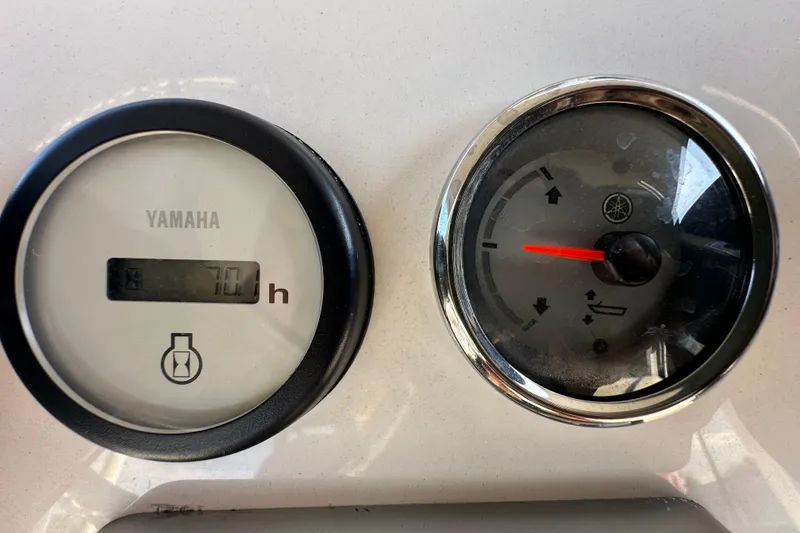 Slide: The Image of Yamaha gauges on 2022 NauticStar 195 XTS boat dashboard, showing 70 hours. - 28