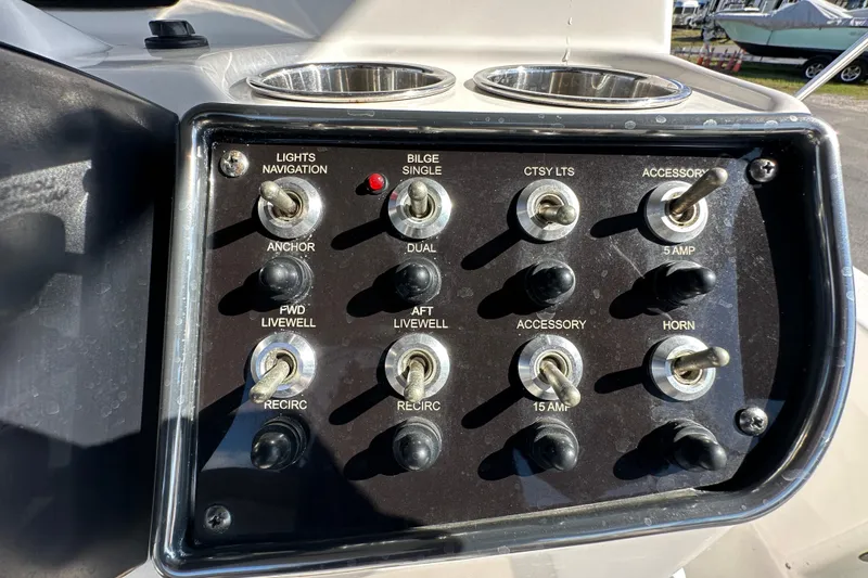 Slide: The Image of Control panel of 2022 NauticStar 195 XTS boat with various switches and indicators. - 35