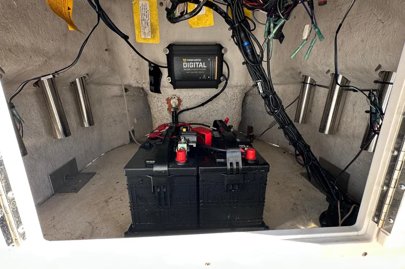 Slide: The Image of 2022 NauticStar 195 XTS boat battery compartment with wiring and digital components. - 40