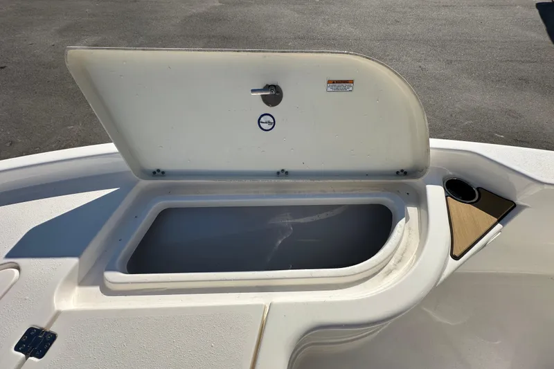 Slide: The Image of Open storage compartment on 2022 NauticStar 195 XTS boat deck. - 49