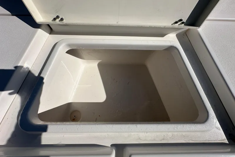 Slide: The Image of Open storage compartment on 2022 NauticStar 195 XTS boat. - 54