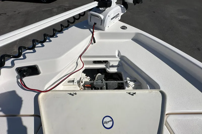 Slide: The Image of 2022 NauticStar 195 XTS boat with Minn Kota trolling motor and open storage compartment. - 55