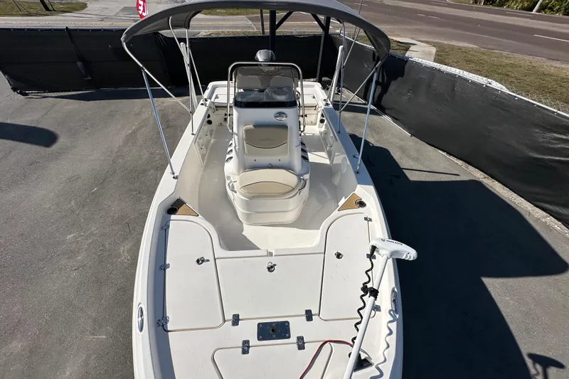 Slide: The Image of 2022 NauticStar 195 XTS boat with canopy, viewed from above, parked on pavement. - 63