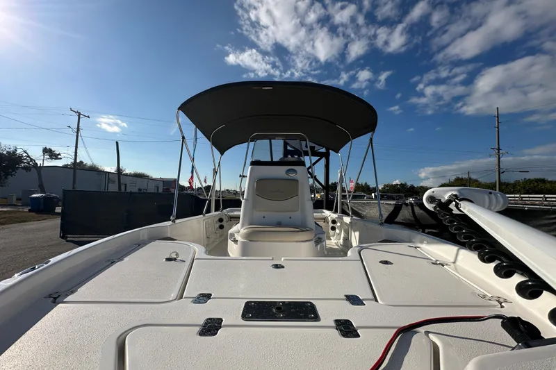 Slide: The Image of 2022 NauticStar 195 XTS boat with canopy, viewed from the deck under a blue sky. - 65