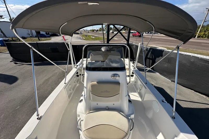 Slide: The Image of 2022 NauticStar 195 XTS boat with canopy, parked on pavement under clear sky. - 67