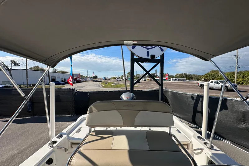 Slide: The Image of 2022 NauticStar 195 XTS boat with canopy, parked near a road. - 71