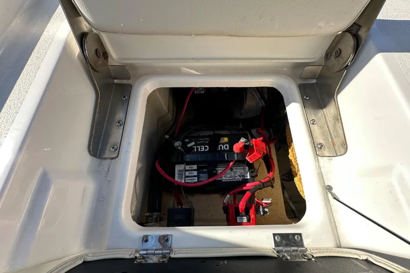 Slide: The Image of Open battery compartment of 2022 NauticStar 195 XTS boat, showing wiring and connections. - 77