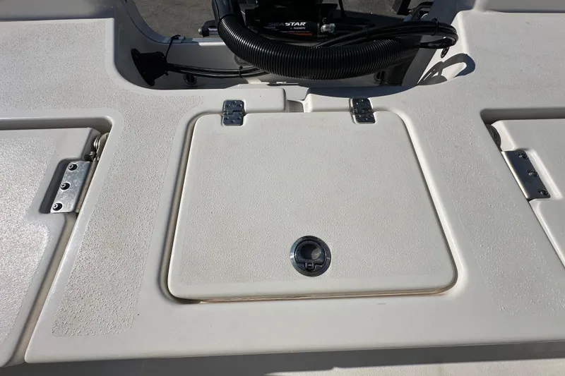 Slide: The Image of 2022 NauticStar 195 XTS boat deck with storage compartment and hinges. - 79