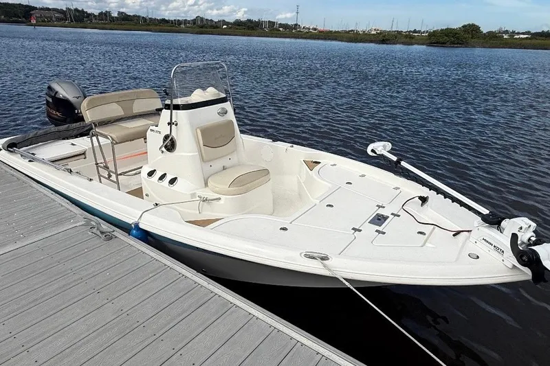 Slide: The Image of 2022 NauticStar 195 XTS boat with Yamaha 115 engine, parked on a sunny day. - 8