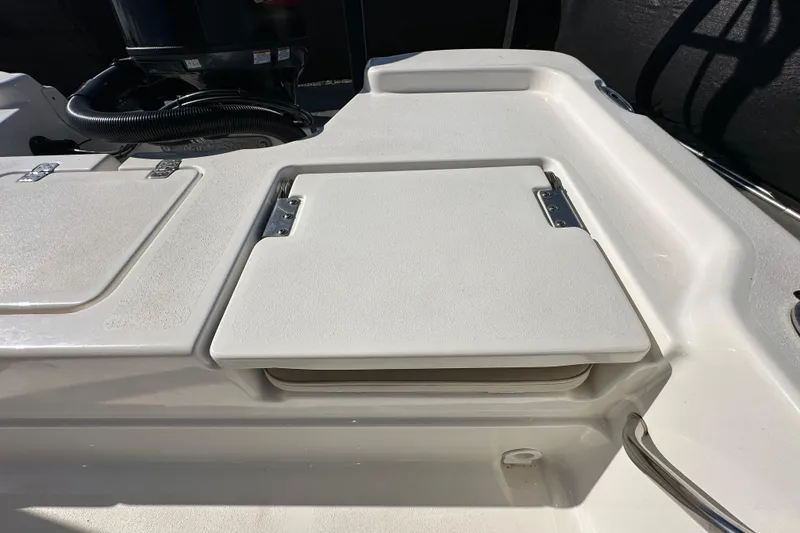 Slide: The Image of 2022 NauticStar 195 XTS boat deck with storage compartments and engine detail. - 82