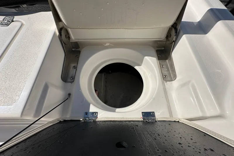 Slide: The Image of 2022 NauticStar 195 XTS boat storage compartment with open hatch, showcasing interior details. - 84