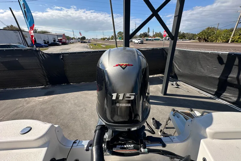 Slide: The Image of 2022 NauticStar 195 XTS with Yamaha 115 outboard motor in a parking lot. - 87