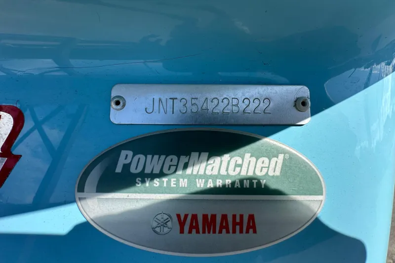 Slide: The Image of Trailer wheel of 2022 NauticStar 195 XTS boat on a black chock. - 89