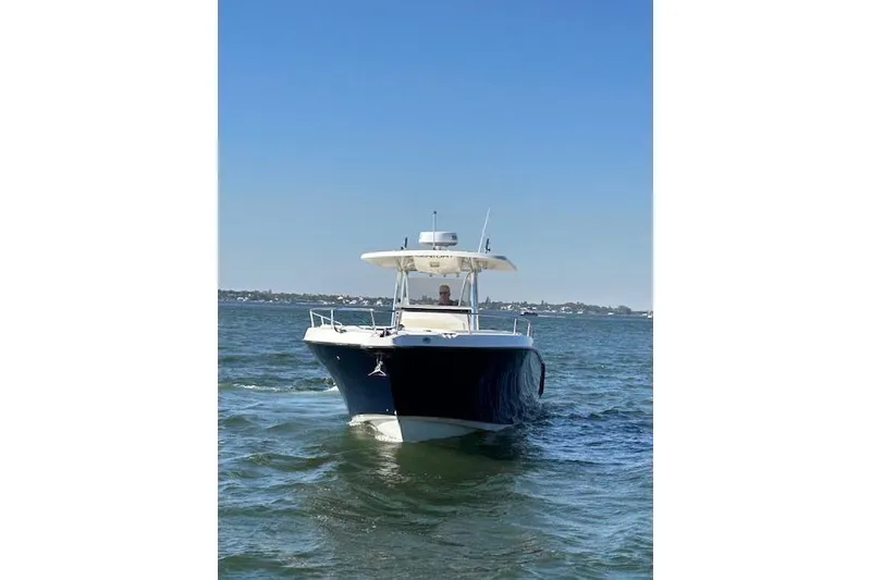 Slide: The Image of 2006 Century 3200 Center Console boat cruising on open water under clear blue sky. - 1
