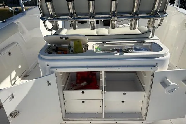 Slide: The Image of 2006 Century 3200 Center Console boat with open storage compartments and fishing rod holders. - 13