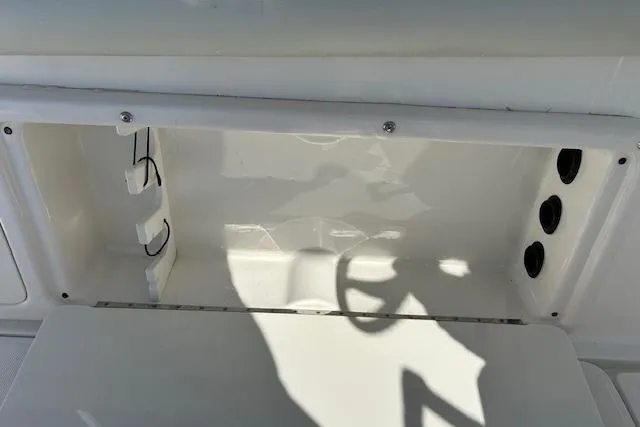 Slide: The Image of Storage compartment on a 2006 Century 3200 Center Console boat, featuring wiring and ventilation. - 16