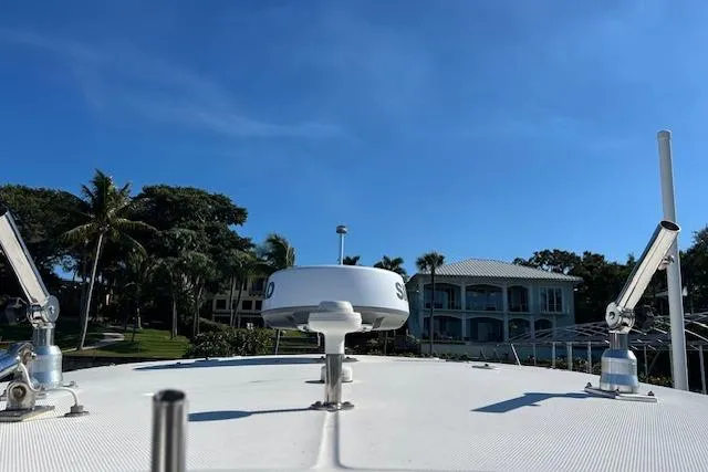 Slide: The Image of Century 3200 Center Console boat, 2006 model, with radar, against a clear blue sky. - 17