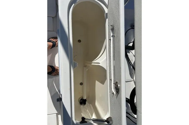 Slide: The Image of Open storage compartment on 2006 Century 3200 Center Console boat. - 21