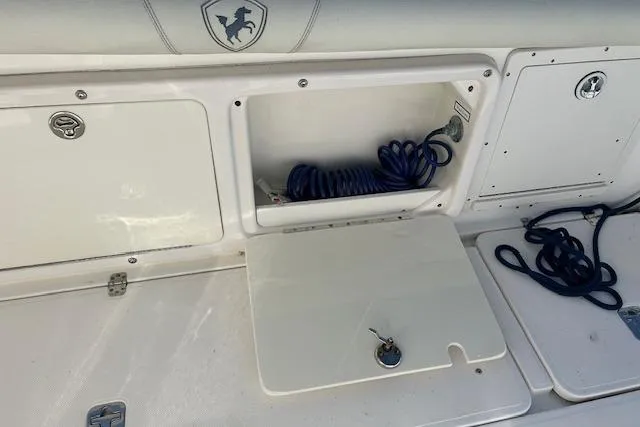 Slide: The Image of 2006 Century 3200 Center Console storage compartment with coiled blue rope. - 29