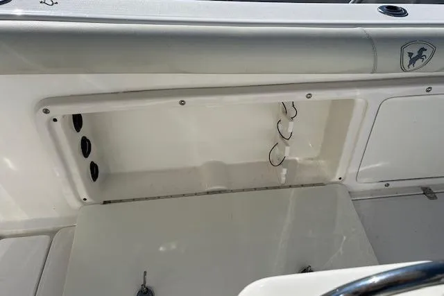 Slide: The Image of 2006 Century 3200 Center Console boat interior with storage compartment and seating. - 31