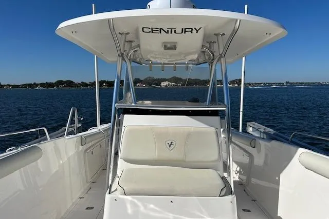 Slide: The Image of 2006 Century 3200 Center Console boat on calm water, featuring spacious seating and sleek design. - 34