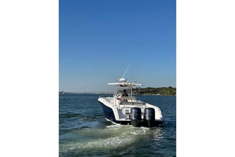 Slide: The Image of 2006 Century 3200 Center Console boat cruising on open water under clear blue sky. - 4