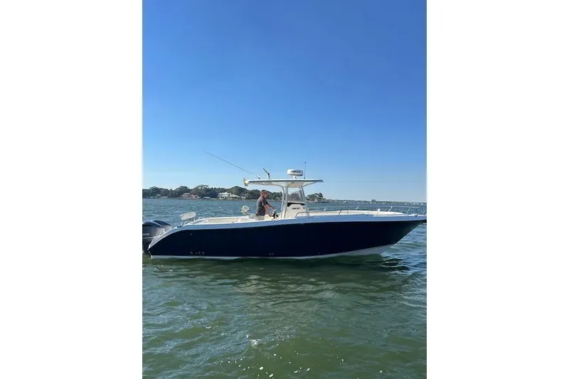 Slide: The Image of 2006 Century 3200 Center Console boat on calm water under clear blue sky. - 5
