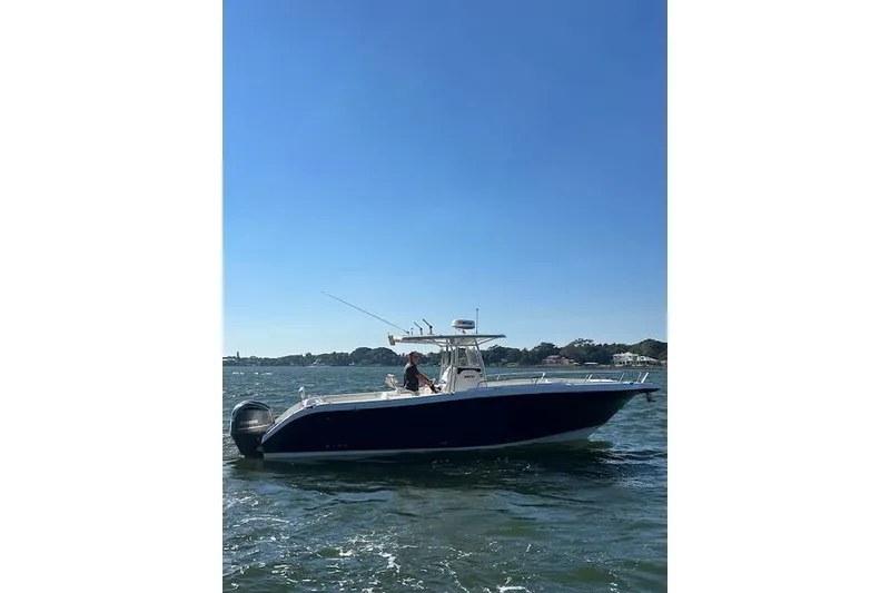 Slide: The Image of 2006 Century 3200 Center Console boat cruising on a sunny day. - 6