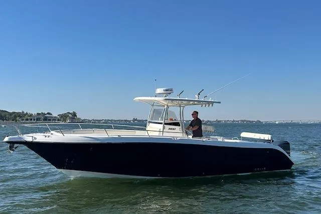 Slide: The Image of 2006 Century 3200 Center Console boat on water, clear sky background. - 8