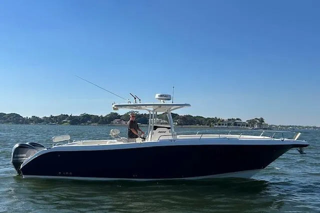 Slide: The Image of 2006 Century 3200 Center Console boat on water under clear blue sky. - 9
