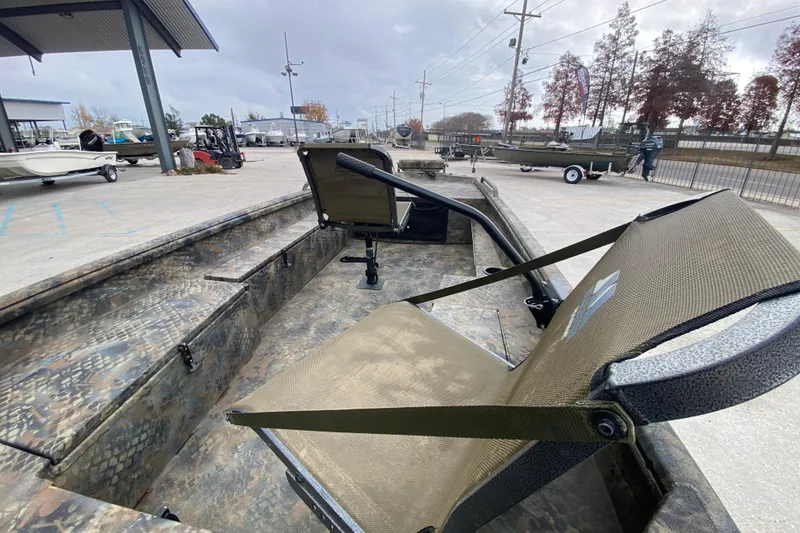 Slide: The Image of 2023 Excel F86 boat interior with camouflage design and seating, displayed outdoors. - 11