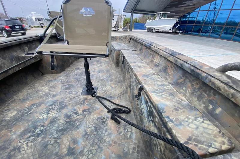 Slide: The Image of Camouflage-patterned Excel F86 boat interior with swivel seat, 2023 model, parked near showroom. - 16