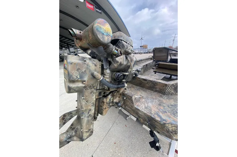 Slide: The Image of Camo-patterned Excel F86 boat engine, 2023 model, displayed outdoors. - 18