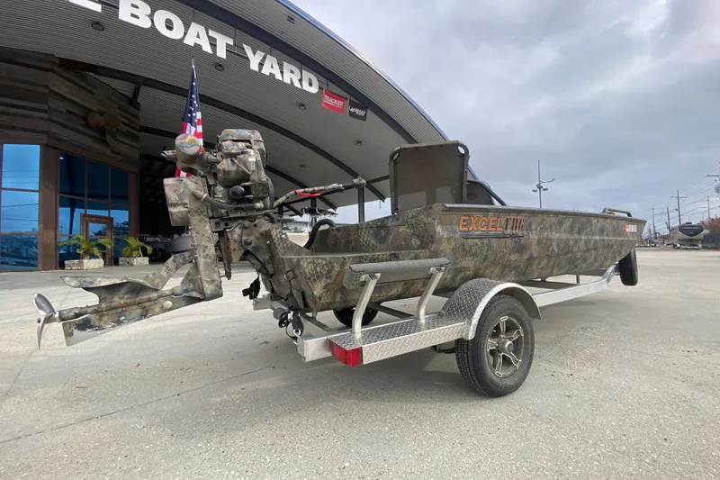 Slide: The Image of Camo-patterned 2023 Excel F86 boat on trailer at boat yard entrance. - 3